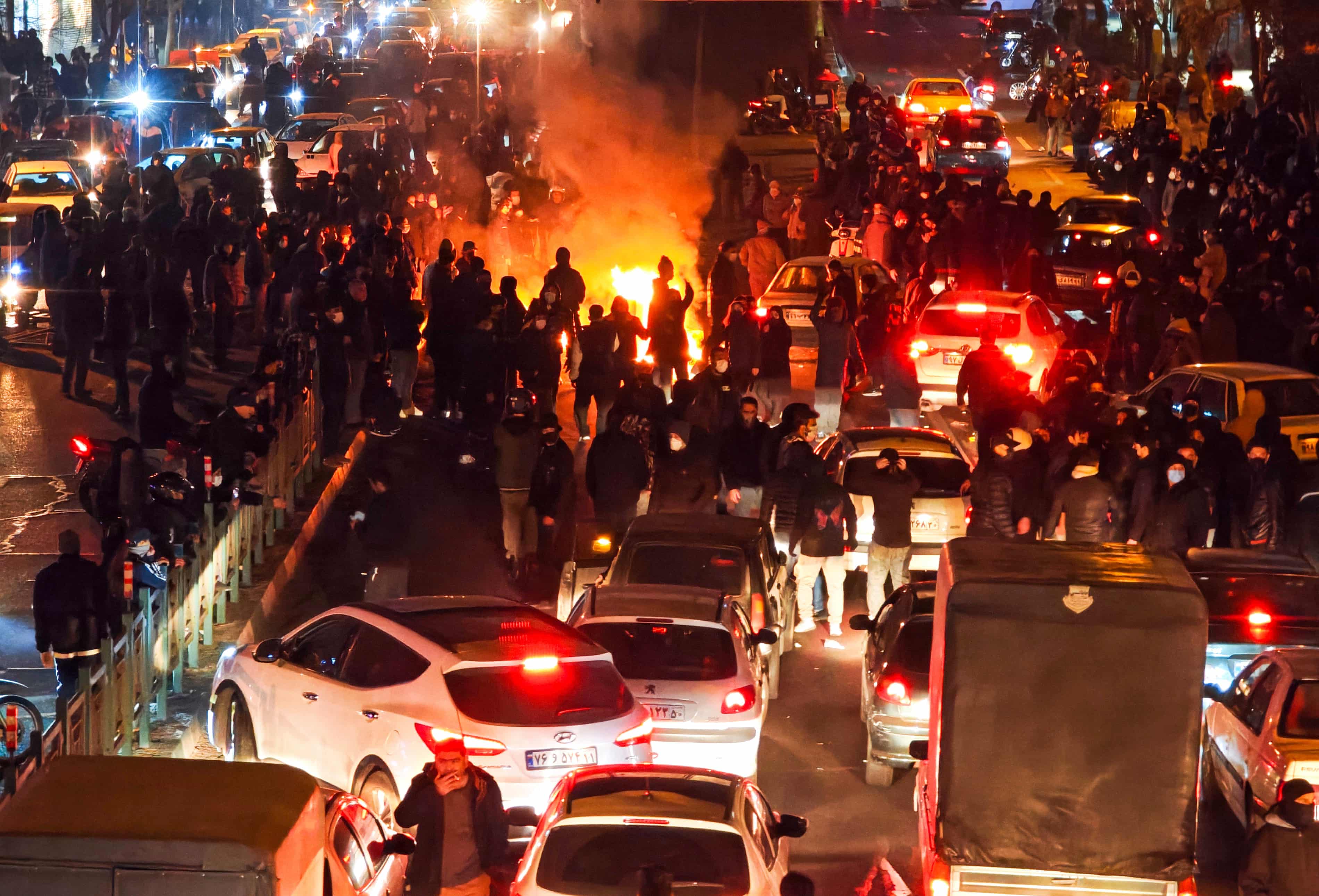 Protesters fill a Tehran street at night during demonstrations triggered by soaring inflation that expanded into broader demands for political change.